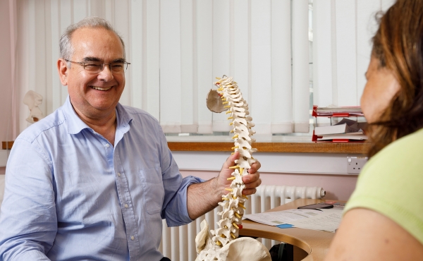 Clinician smiling with spine model